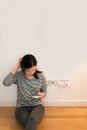 Cute asian girl frustrating with phone, charging battery, with copy space Royalty Free Stock Photo