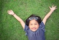 Cute Asian girl laying on Greenery Field