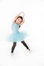 Cute Asian girl in light blue dress preforming ballet with smiling face, isolated on white background Royalty Free Stock Photo