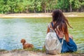 Cute asian girl with little dog walking in park. Woman sitting on green grass with dog - outdoor in nature portrait. Pet, domestic Royalty Free Stock Photo