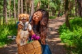 Cute asian girl with little dog walking in park. Woman sitting on green grass with dog - outdoor in nature portrait. Pet, domestic Royalty Free Stock Photo