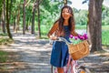 Cute asian girl with little dog walking in park. Woman sitting on green grass with dog - outdoor in nature portrait. Pet, domestic Royalty Free Stock Photo