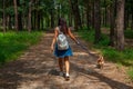 Cute asian girl with little dog walking in park. Woman sitting on green grass with dog - outdoor in nature portrait. Pet, domestic Royalty Free Stock Photo