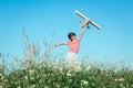 Cute asian girl playing toy plane as pilot imagination to the future at flower grass field vintage filtered. Royalty Free Stock Photo