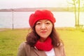 A cute asian girl in a red beret smiling happily