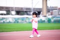Cute Asian girl showing insecure or embarrassed expression. Children walking on the playground. Kid aged 4-5 years old.