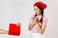 The cute Asian girl is shy when someone give gift box to her.