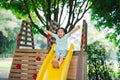 Cute asian girl smile play on school or kindergarten yard or playground. Healthy summer activity for children. Little asian girl Royalty Free Stock Photo