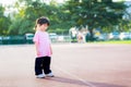 Cute Asian girl is standing making scheming face. Kid thinking and shows a thoughtful face. Happy child aged 4 years old. Royalty Free Stock Photo