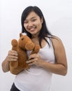 Cute happy asian girl with a teddy horse smiling