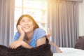 Girl teen lazy day hand at chin on bed looking high thinking missing daydreaming Royalty Free Stock Photo