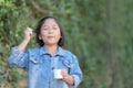 Cute asian girl wear jeans jacket enjoy eating ice-cream