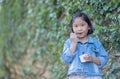 Cute asian girl wear jeans jacket enjoy eating ice-cream