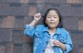 Cute asian girl wear jeans jacket enjoy eating ice-cream
