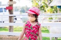 Cute Asian girl wearing orange cloth face mask. Child visit zoo during the coronavirus outbreak. Prevent air pollution PM2.5 dust Royalty Free Stock Photo