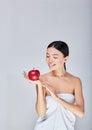 Cute Asian holds a red apple in her hand