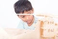 Close up of cute asian ittle boy play wooden plane Royalty Free Stock Photo