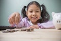 Cute Asian kid girl smile happiness is counting money for saving money to the future. Concept to save money for education. Ideas Royalty Free Stock Photo