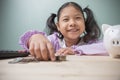 Cute Asian kid girl smile happiness is counting money for saving money to the future. Concept to save money for education. Ideas Royalty Free Stock Photo