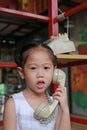 Cute asian kid girl using the retro telephone Royalty Free Stock Photo