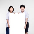 Cute Asian kids in student`s uniform with white board Royalty Free Stock Photo