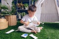 Cute Asian kindergarten boy cutting a piece of paper, Introduce scissor skills for toddlers, Little kid enjoying doing arts &