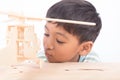 Close up of cute asian little boy play wooden plane