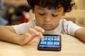 Cute asian little boy is playing a game on smartphone Royalty Free Stock Photo