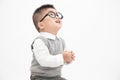 Cute Asian little boy wearing white shirt, grey vest and glasses isolated on white background.