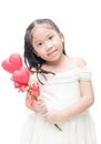 Cute asian little bridesmaid holding heart flower isolated. Royalty Free Stock Photo
