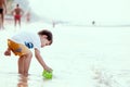 Cute asian little child boy having fun to play on beach Royalty Free Stock Photo