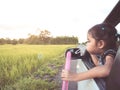 Cute asian little child girl blowing bubble out of car window Royalty Free Stock Photo