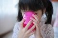 Cute asian little child girl drinking fresh water from glass Royalty Free Stock Photo