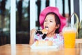 Cute asian little child girl eating delicious toast