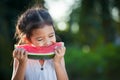 Cute asian little child girl eating watermelon fresh fruit Royalty Free Stock Photo