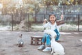 Cute asian little child girl feeding rabbit Royalty Free Stock Photo