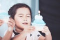 Cute asian little child girl holding birthday cupcake Royalty Free Stock Photo