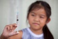 Cute asian little child girl holding injection syringe Royalty Free Stock Photo