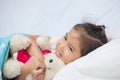 Cute asian little child girl hugging her teddy bear Royalty Free Stock Photo