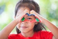 Cute asian little child girl with painted hands make heart shape colorful Royalty Free Stock Photo