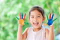 Cute asian little child girl with painted hands smiling with fun Royalty Free Stock Photo