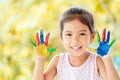 Cute asian little child girl with painted hands smiling with fun Royalty Free Stock Photo