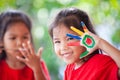 Cute asian little child girl with painted hands smiling Royalty Free Stock Photo