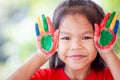 Asian little child girl with painted hands smiling with fun and happiness Royalty Free Stock Photo