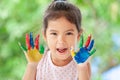 Cute asian little child girl with painted hands smiling with fun Royalty Free Stock Photo