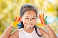 Cute asian little child girl with painted hands smiling with fun Royalty Free Stock Photo