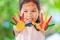 Cute asian little child girl with painted hands smiling with fun Royalty Free Stock Photo