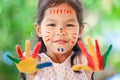 Cute asian little child girl with painted hands smiling with fun Royalty Free Stock Photo