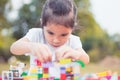 Cute asian little child girl playing with colorful blocks. Royalty Free Stock Photo