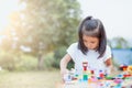 Cute asian little child girl playing with colorful toy blocks Royalty Free Stock Photo